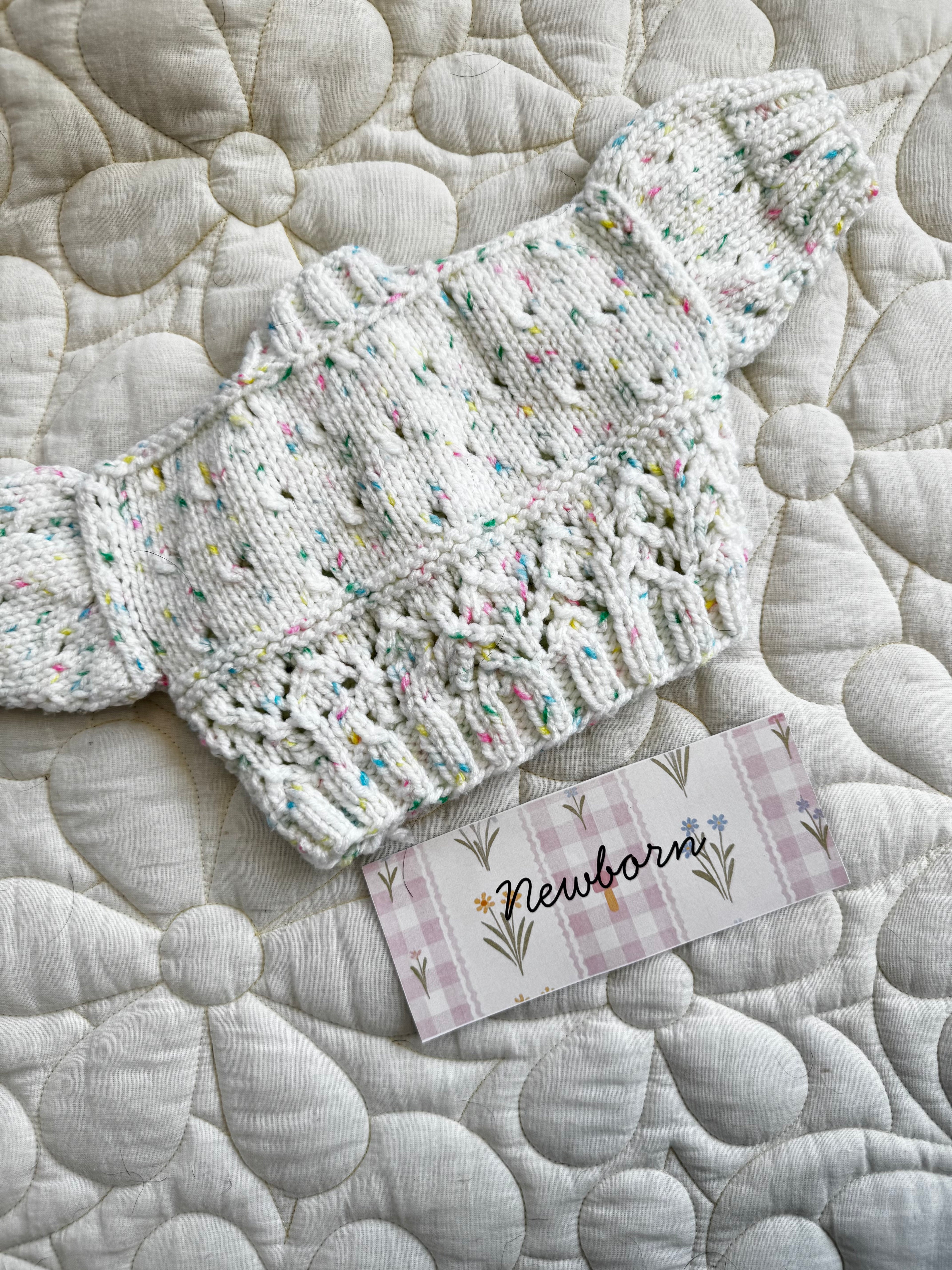 Newborn speckled multicoloured hand knit