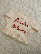 ‘Believes’ cardigan